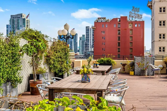 a view of a patio with couches table and chairs and potted plants