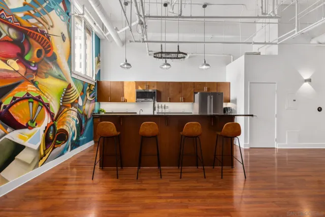 a kitchen with stainless steel appliances kitchen island granite countertop a table and chairs