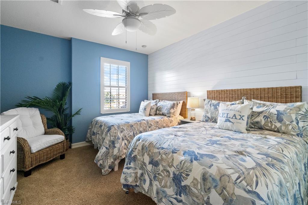 9111 Capistrano Street South, Unit 8303 Naples, FL 34113 - Photo 12 of 29 a bedroom with a large bed and a couch