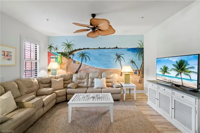 a living room with furniture a chandelier and a flat screen tv