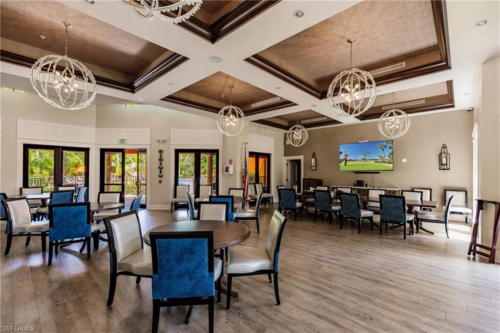 9111 Capistrano Street South, Unit 8303 Naples, FL 34113 - Photo 22 of 29 a view of a dining room with furniture window and wooden floor