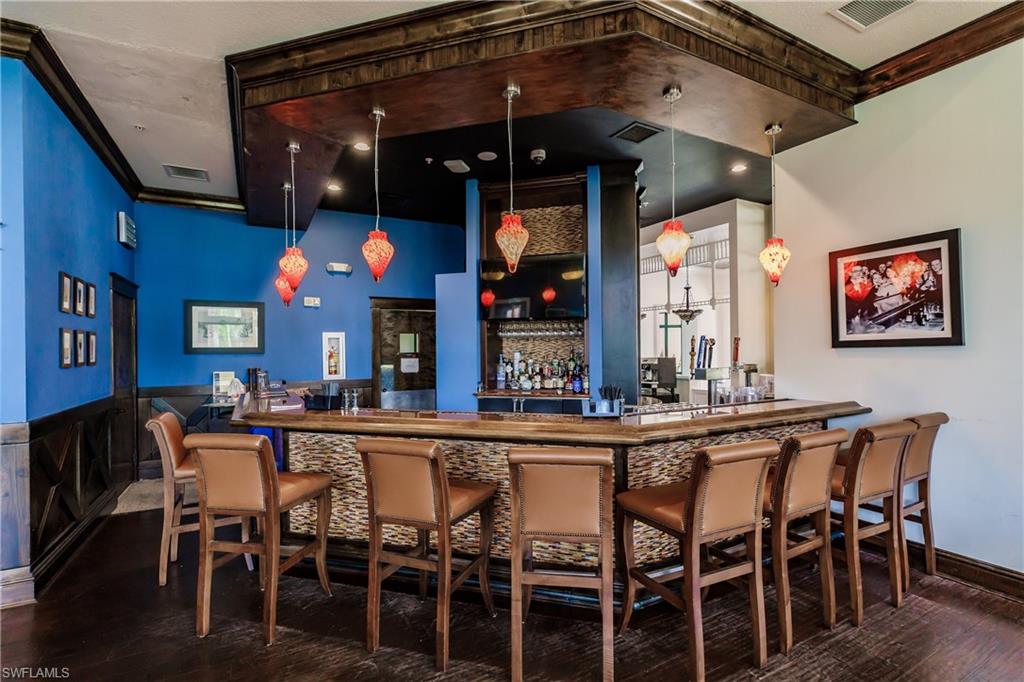 9111 Capistrano Street South, Unit 8303 Naples, FL 34113 - Photo 25 of 29 a view of a dining area with furniture and chandelier