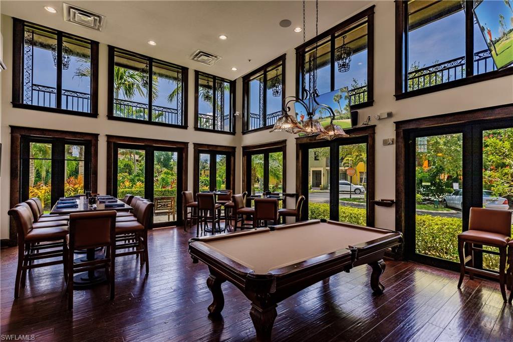 9111 Capistrano Street South, Unit 8303 Naples, FL 34113 - Photo 26 of 29 a view of a dining room with furniture window and wooden floor