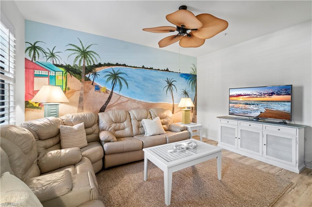9111 Capistrano Street South, Unit 8303 Naples, FL 34113 - Photo 4 of 29 a living room with furniture a rug and a flat screen tv