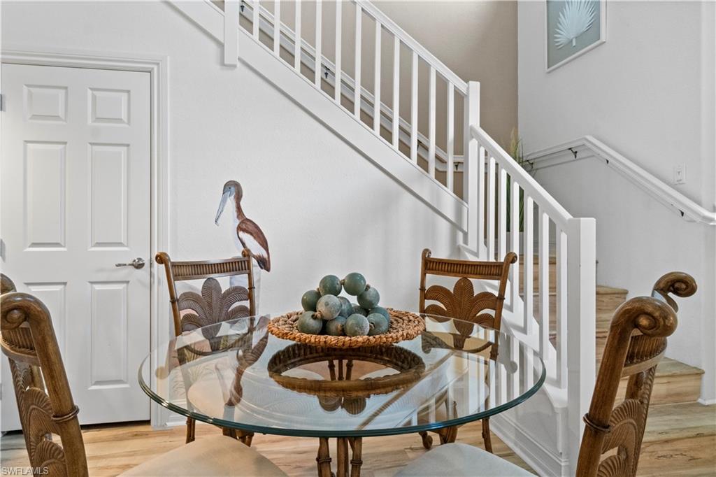 9111 Capistrano Street South, Unit 8303 Naples, FL 34113 - Photo 7 of 29 a dining room with furniture and entryway