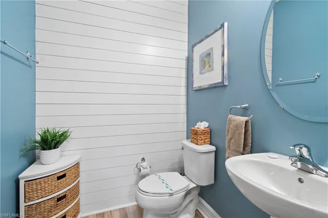 a bathroom with a toilet a sink and mirror