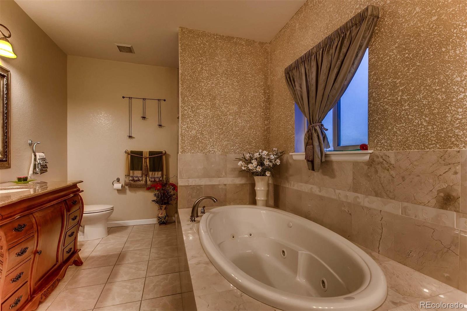 691 Picadilly Road Aurora, CO 80018 - Photo 11 of 27 a bathroom with a bathtub and a sink