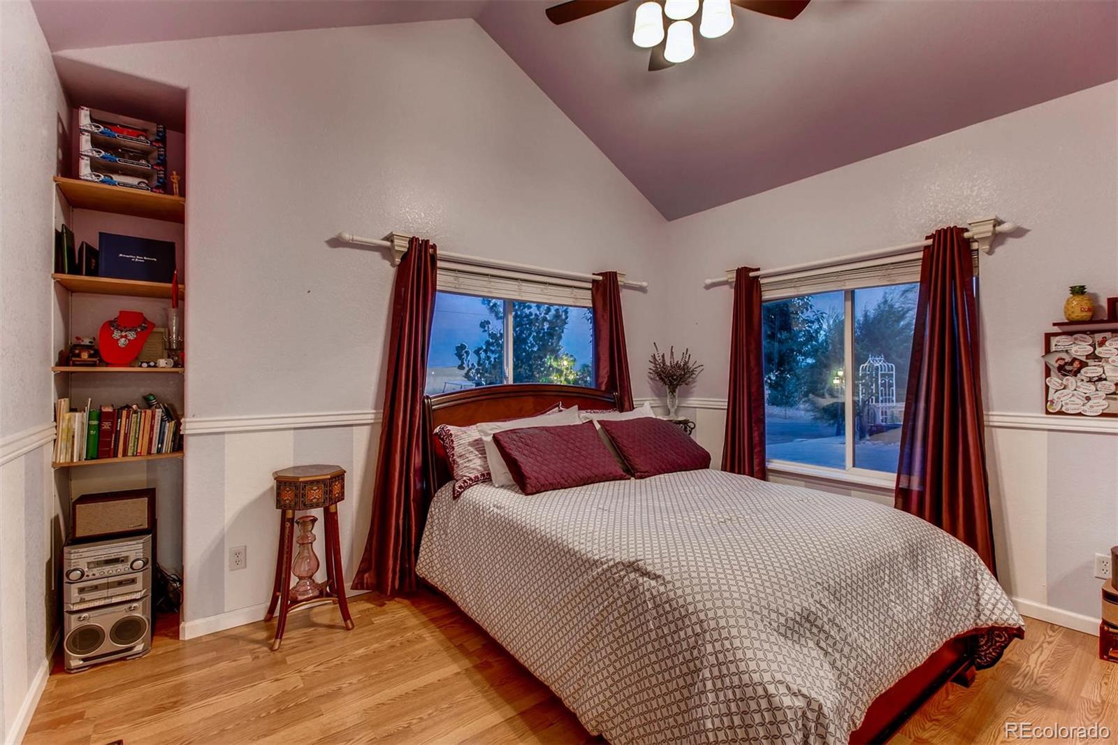 691 Picadilly Road Aurora, CO 80018 - Photo 12 of 27 a bedroom with a bed and a book shelf
