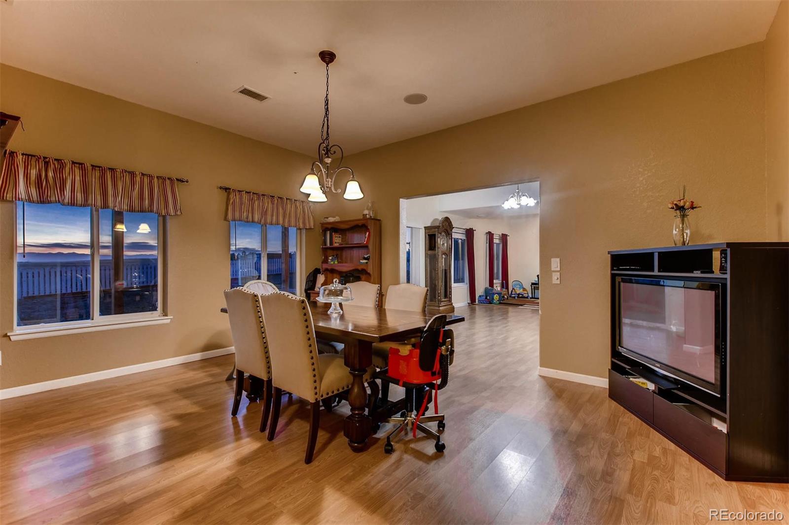 691 Picadilly Road Aurora, CO 80018 - Photo 15 of 27 a view of a dining room with furniture window and wooden floor