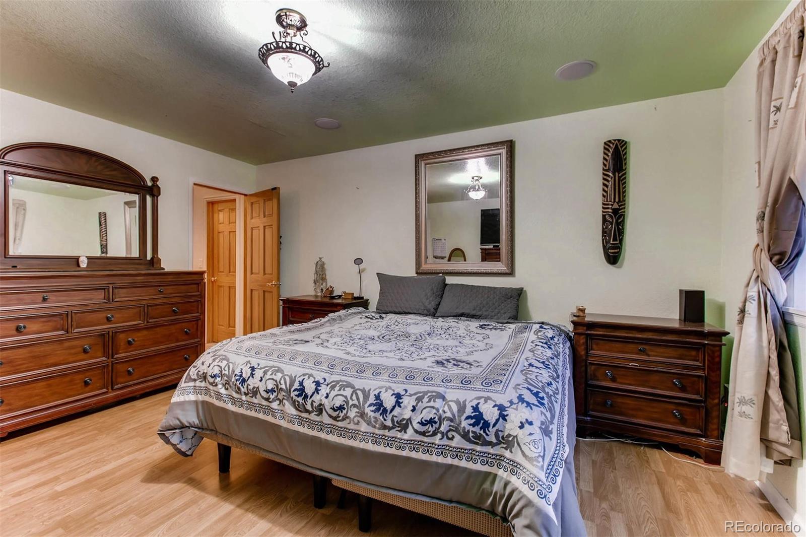 691 Picadilly Road Aurora, CO 80018 - Photo 17 of 27 a bedroom with a bed and a dresser