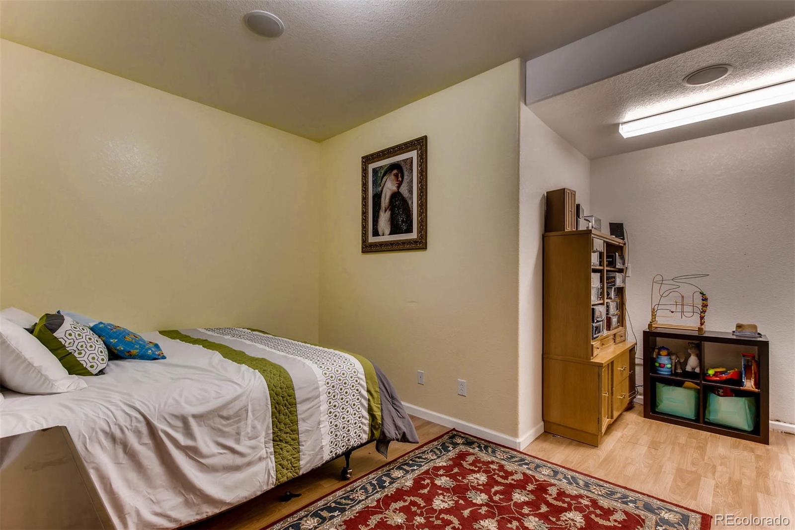 691 Picadilly Road Aurora, CO 80018 - Photo 19 of 27 a bedroom with a bed and a walk in closet