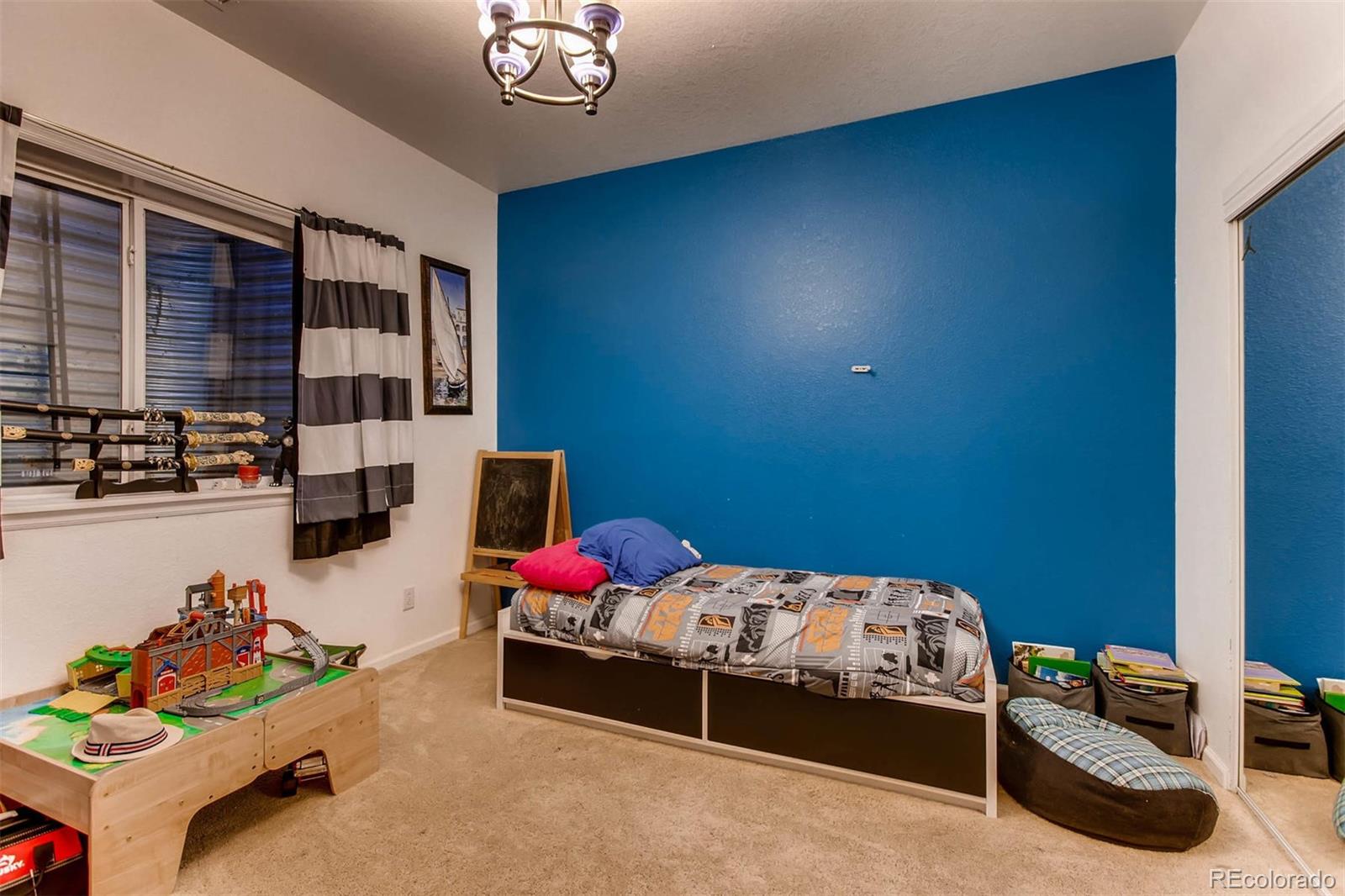 691 Picadilly Road Aurora, CO 80018 - Photo 20 of 27 a bedroom with bed and a window