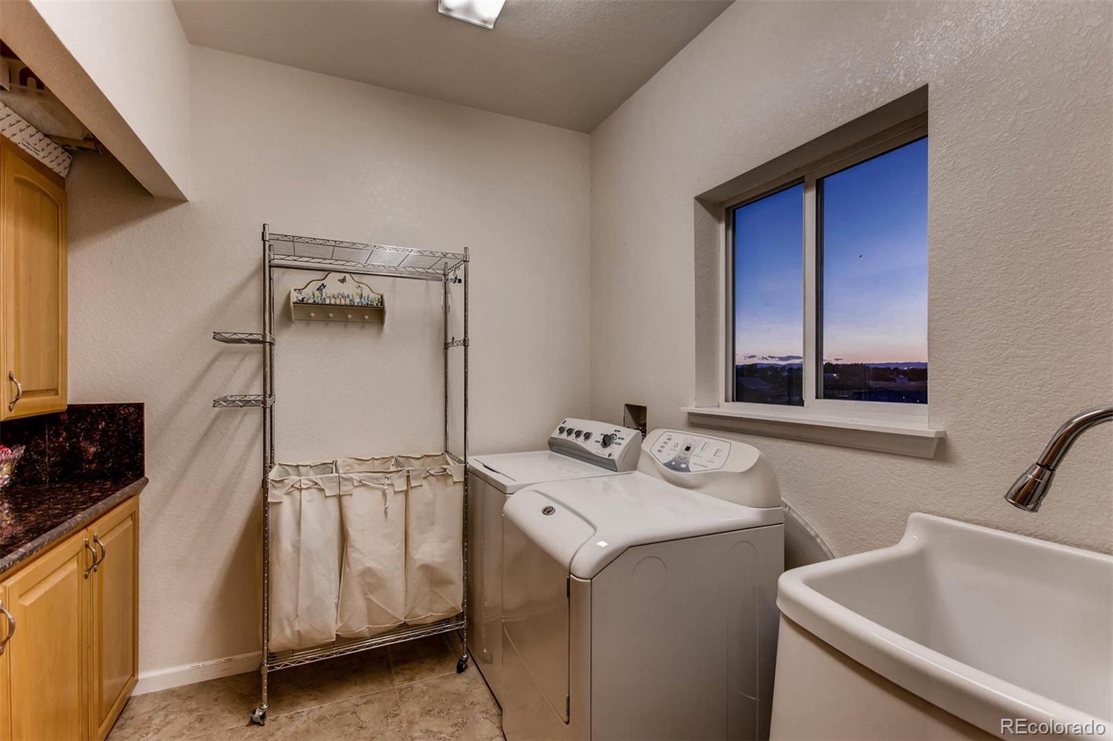 691 Picadilly Road Aurora, CO 80018 - Photo 22 of 27 a utility room with dryer and washer