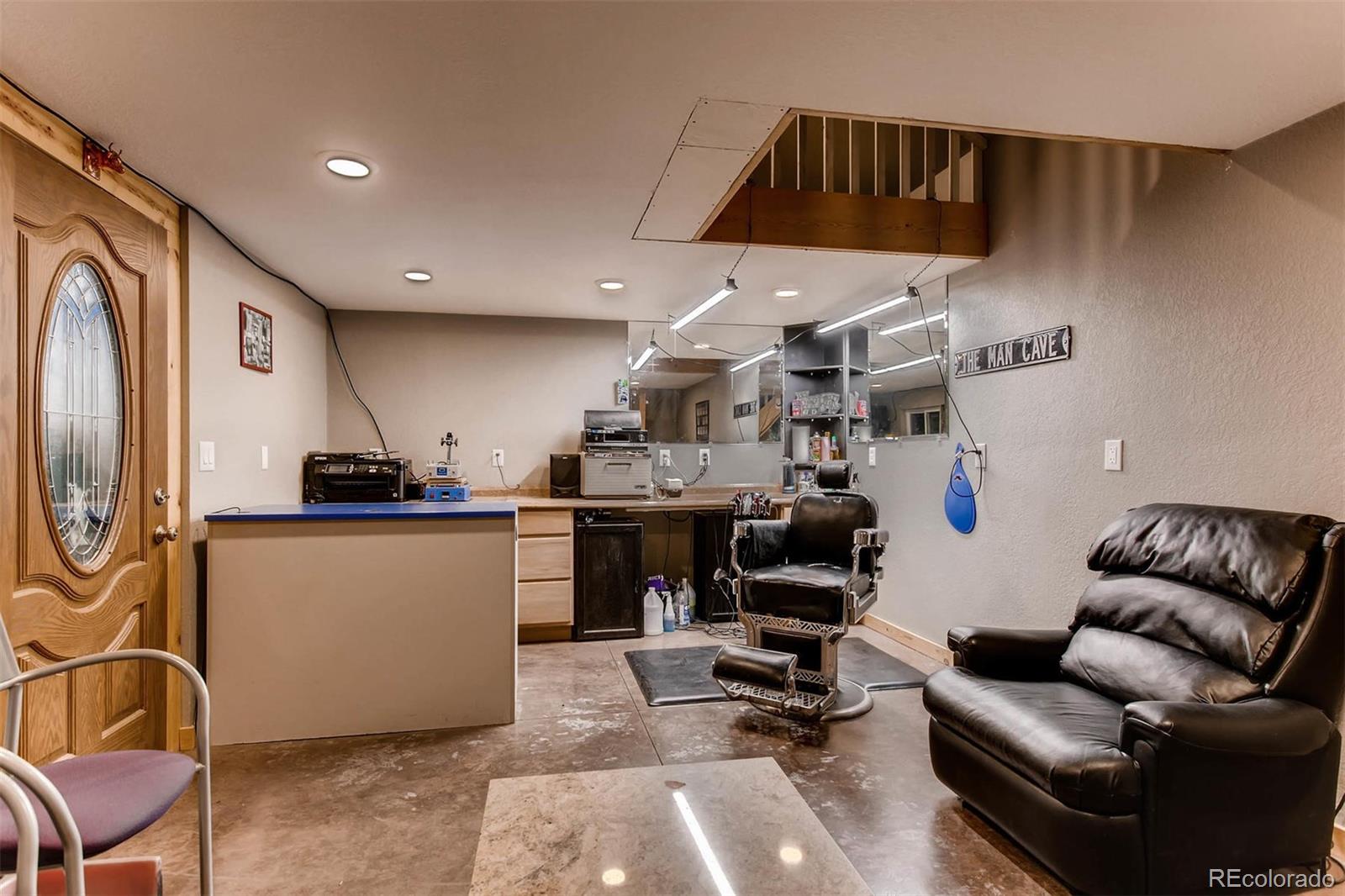 691 Picadilly Road Aurora, CO 80018 - Photo 24 of 27 a living room with furniture and a flat screen tv