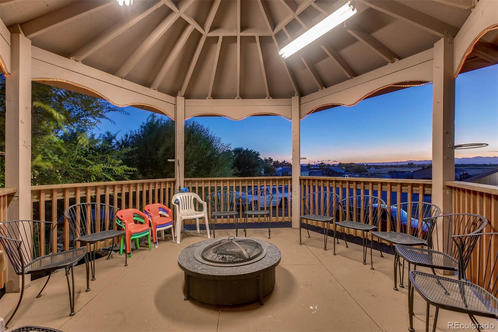 691 Picadilly Road Aurora, CO 80018 - Photo 26 of 27 a view of a roof deck with a chair and wooden floor