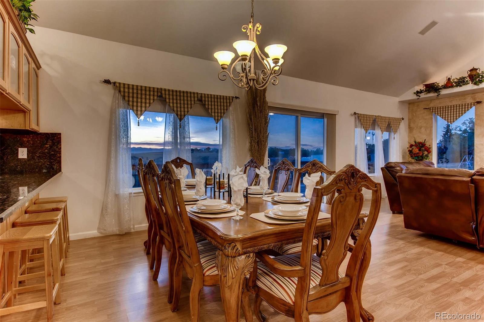 691 Picadilly Road Aurora, CO 80018 - Photo 4 of 27 a view of a dining room with furniture and chandelier