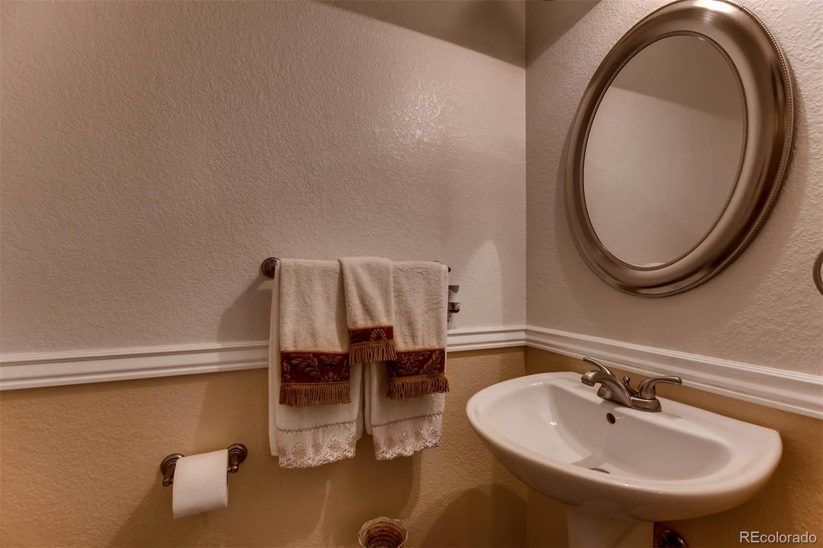 691 Picadilly Road Aurora, CO 80018 - Photo 9 of 27 a bathroom with a sink and a mirror