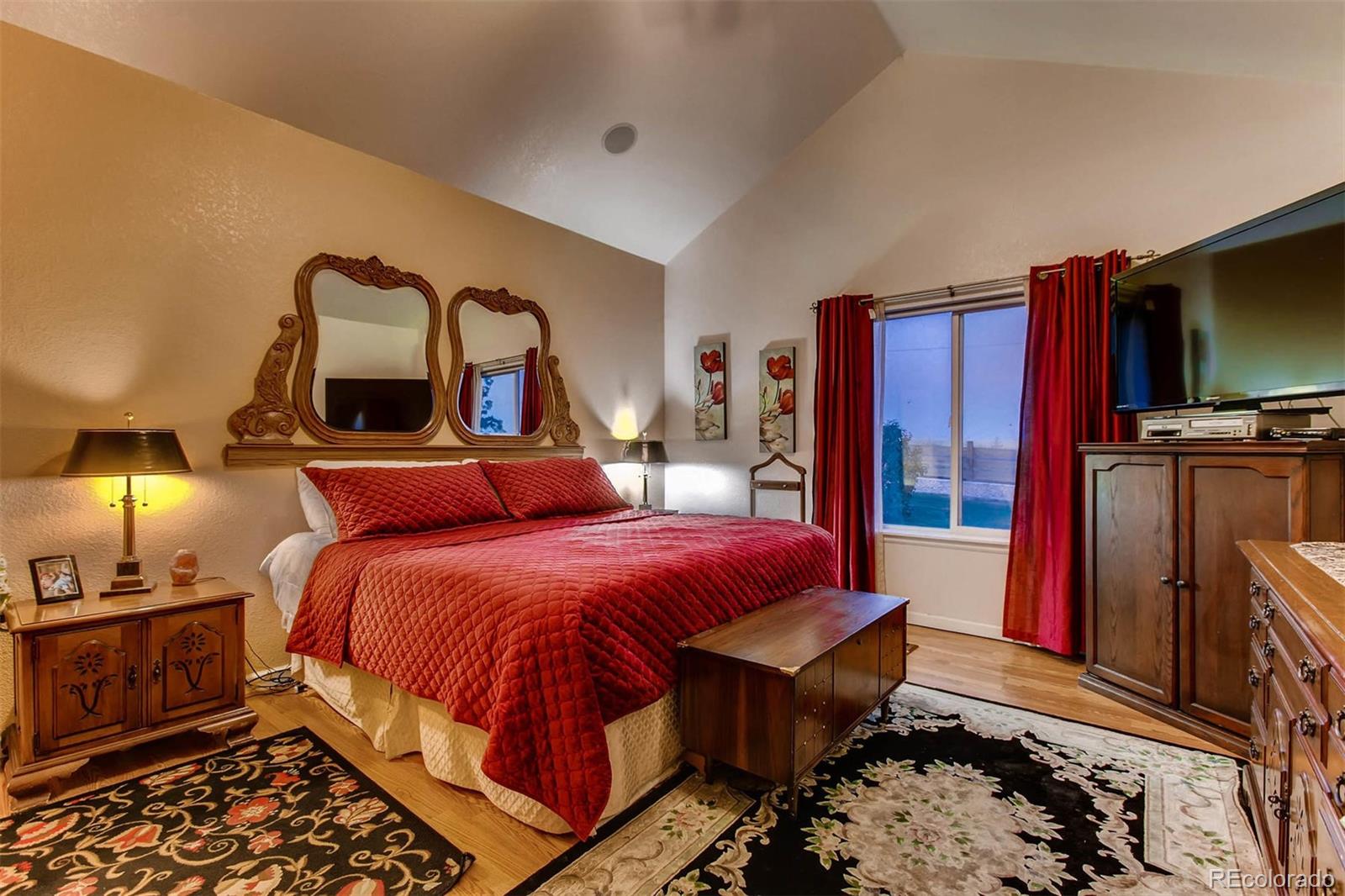 691 Picadilly Road Aurora, CO 80018 - Photo 10 of 27 a bedroom with bed and a flat tv screen on dresser