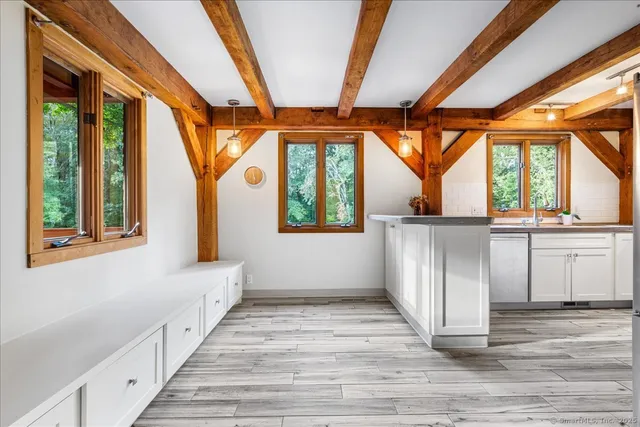 a hallway with furniture and a large window