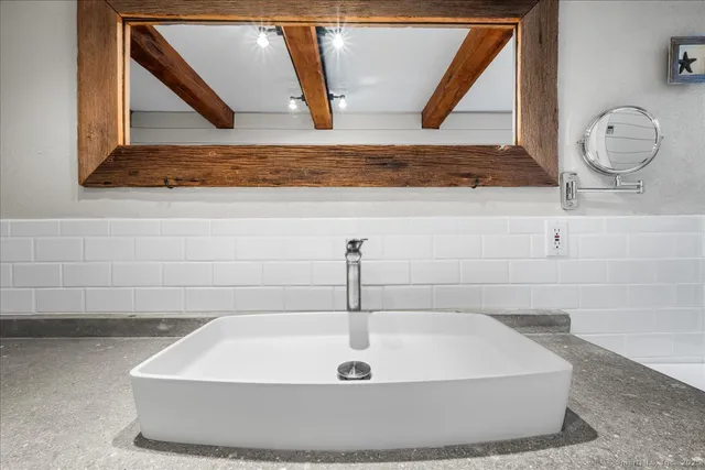 a bathroom with a shower and a sink