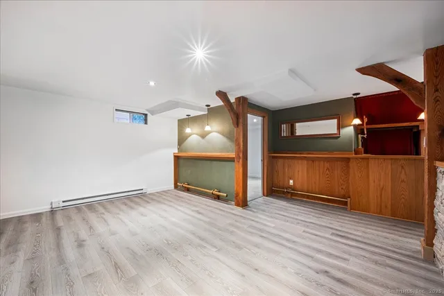 a view of a patio with furniture and a garden