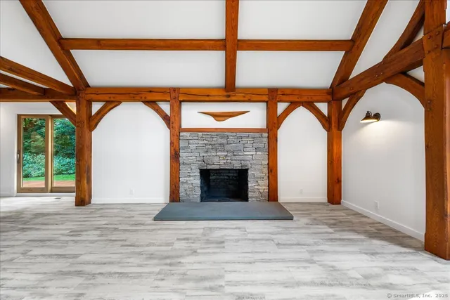 a living room with furniture a fireplace and a large window