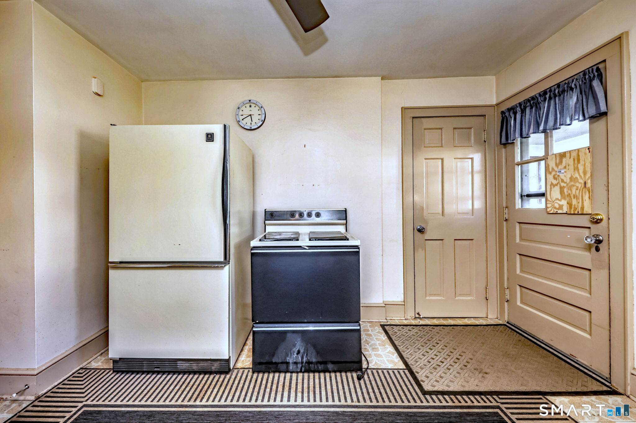 60 Myrtle Street Norwalk, CT 06855 - Photo 12 of 33 a kitchen with a refrigerator and cabinets
