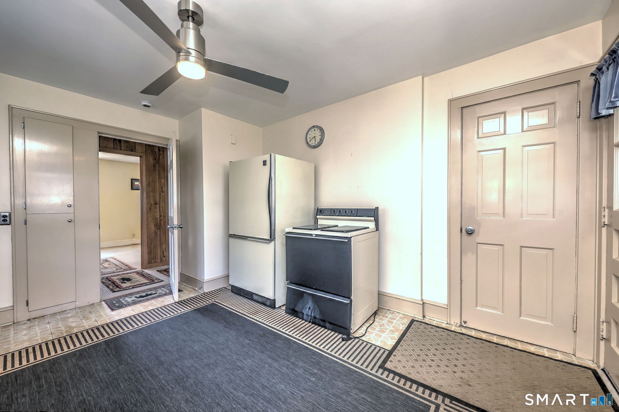 60 Myrtle Street Norwalk, CT 06855 - Photo 15 of 33 a view of a hallway with wooden floor and cabinet with a fireplace