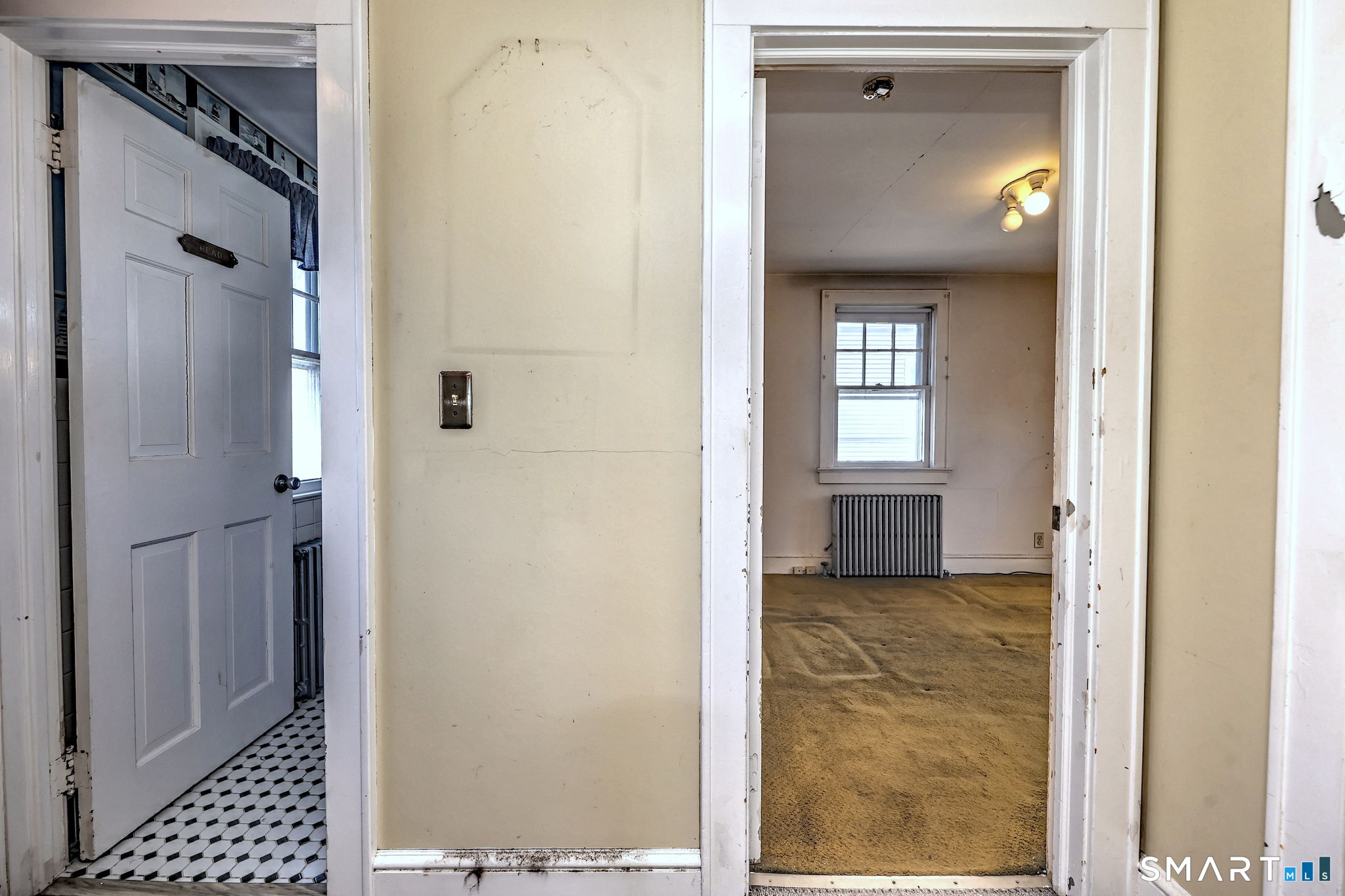60 Myrtle Street Norwalk, CT 06855 - Photo 22 of 33 a view of a hallway with wooden floor and a livingroom