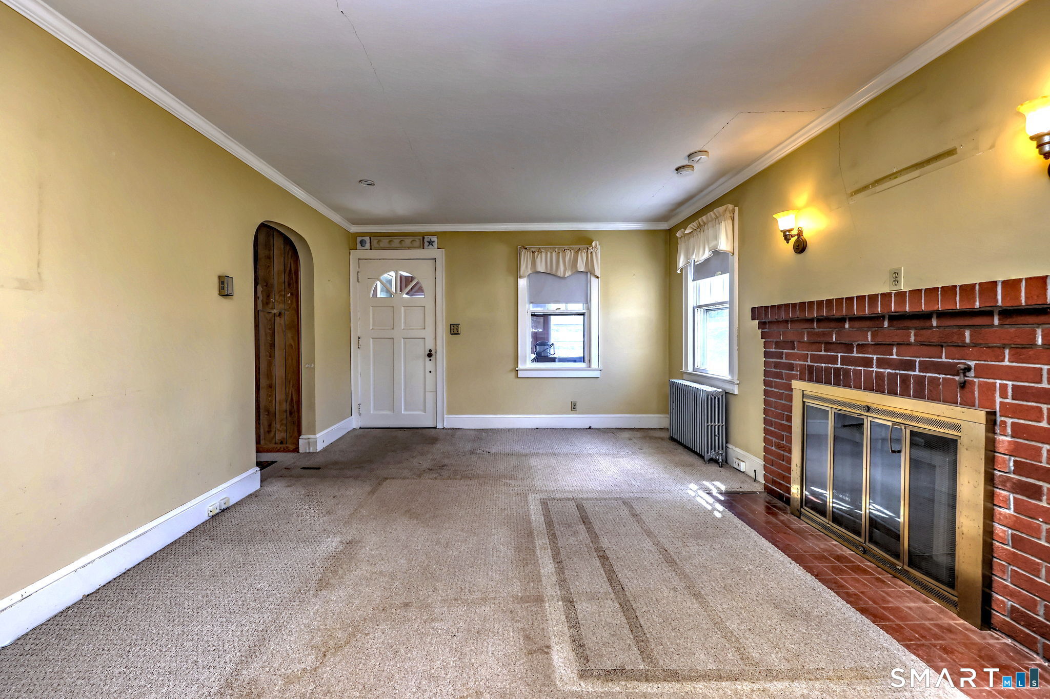 60 Myrtle Street Norwalk, CT 06855 - Photo 6 of 33 a view of empty room with fireplace and windows