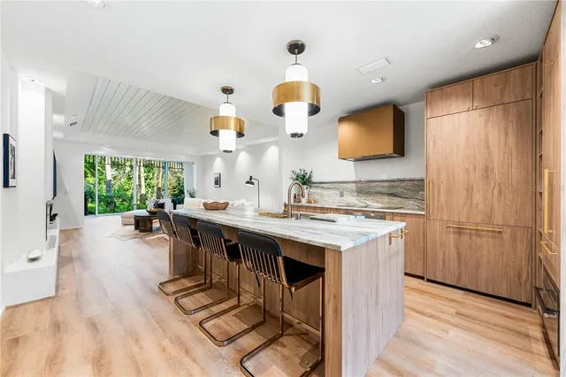 a kitchen with stainless steel appliances granite countertop a sink and a stove