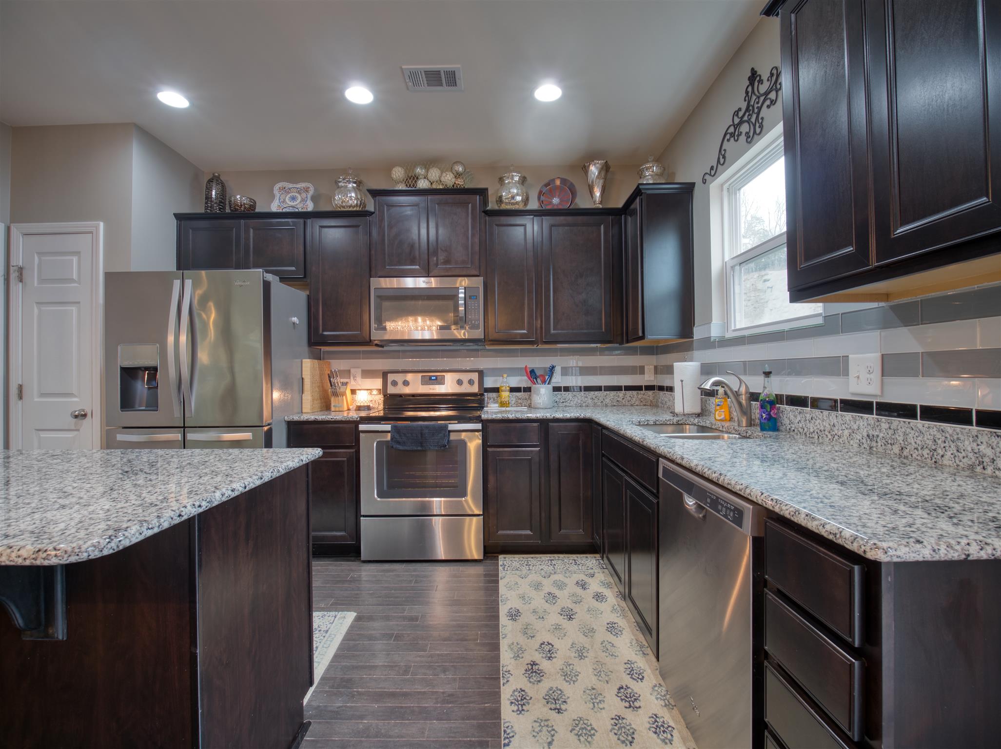 1420 Old Stone Road Lebanon, TN 37087 - Photo 11 of 23 a kitchen with stainless steel appliances granite countertop a sink stove and refrigerator