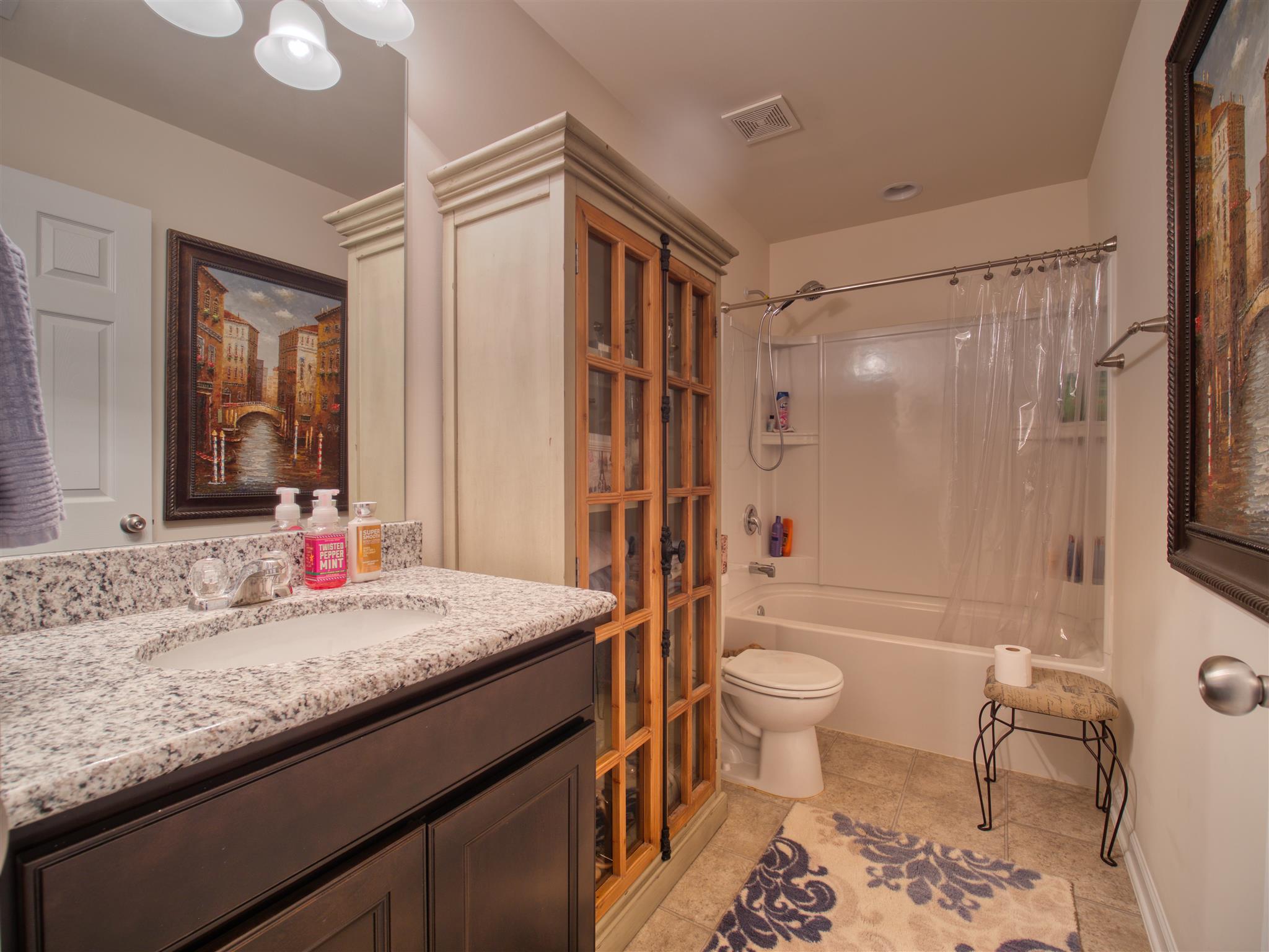 1420 Old Stone Road Lebanon, TN 37087 - Photo 20 of 23 a bathroom with a granite countertop sink toilet and shower