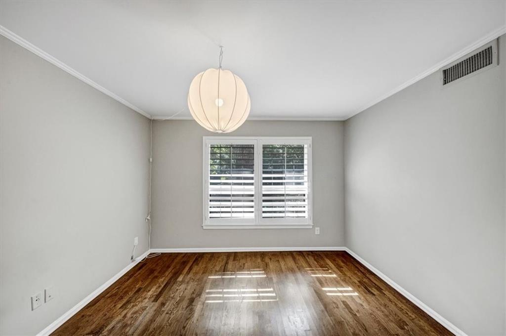 37 La Rue Place Northwest Atlanta, GA 30327 - Photo 16 of 35 a view of an empty room with wooden floor and a window