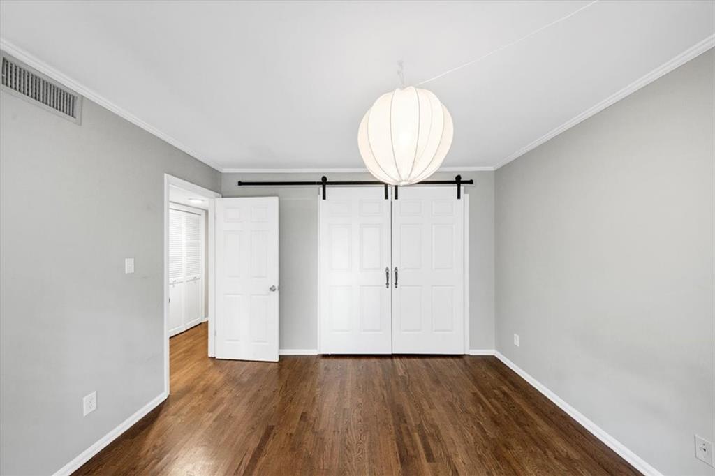 37 La Rue Place Northwest Atlanta, GA 30327 - Photo 17 of 35 a view of an empty room with wooden floor and a window