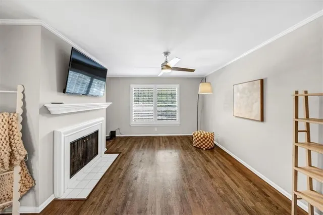 a living room with wooden floors and a fireplace