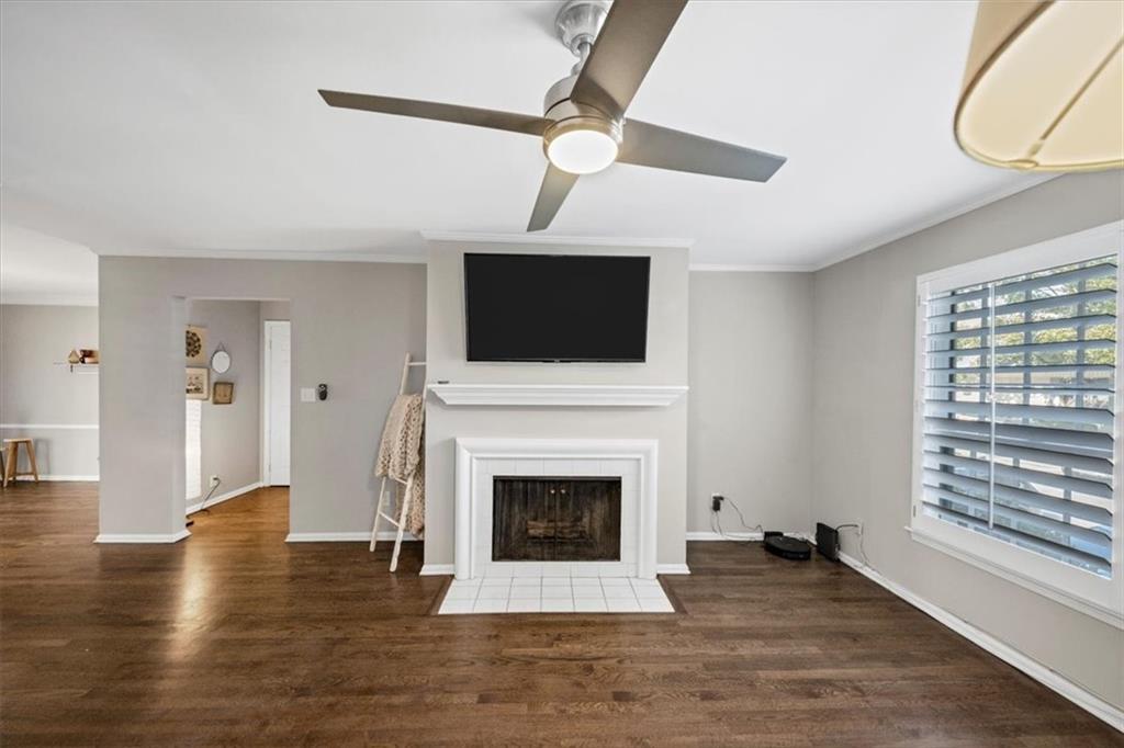 37 La Rue Place Northwest Atlanta, GA 30327 - Photo 4 of 35 a living room with a fireplace and a flat screen tv