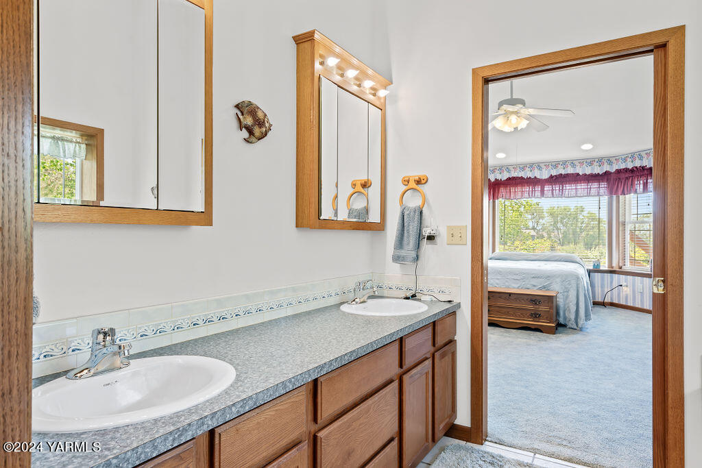 1241 Nelson Road Granger, WA 98932 - Photo 15 of 45 a bathroom with a granite countertop sink and a mirror