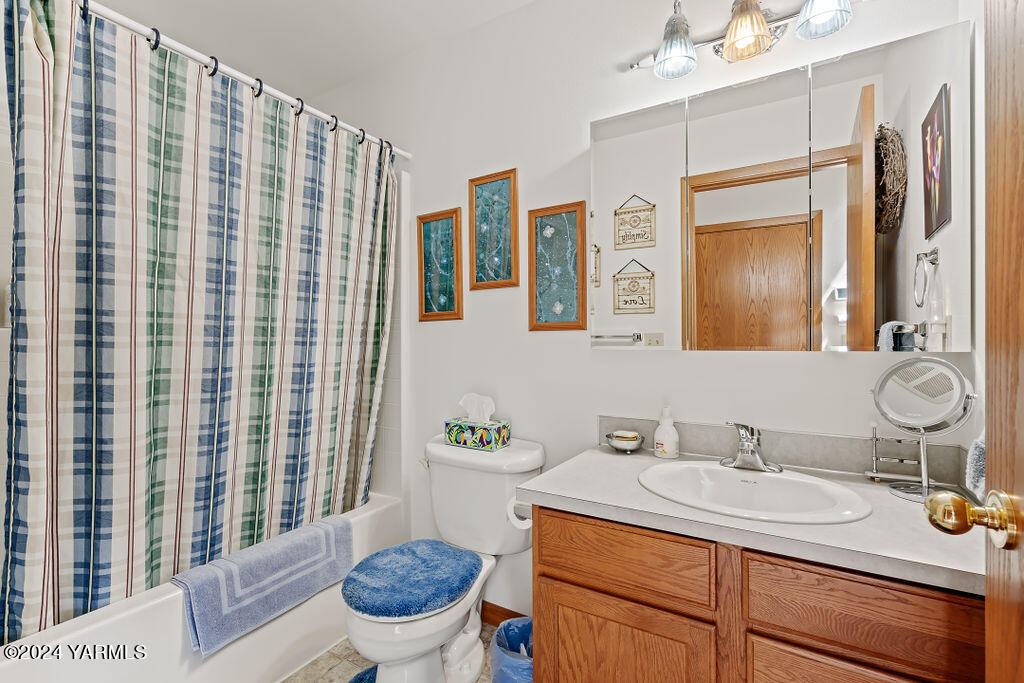 1241 Nelson Road Granger, WA 98932 - Photo 19 of 45 a bathroom with a granite countertop sink mirror vanity and toilet