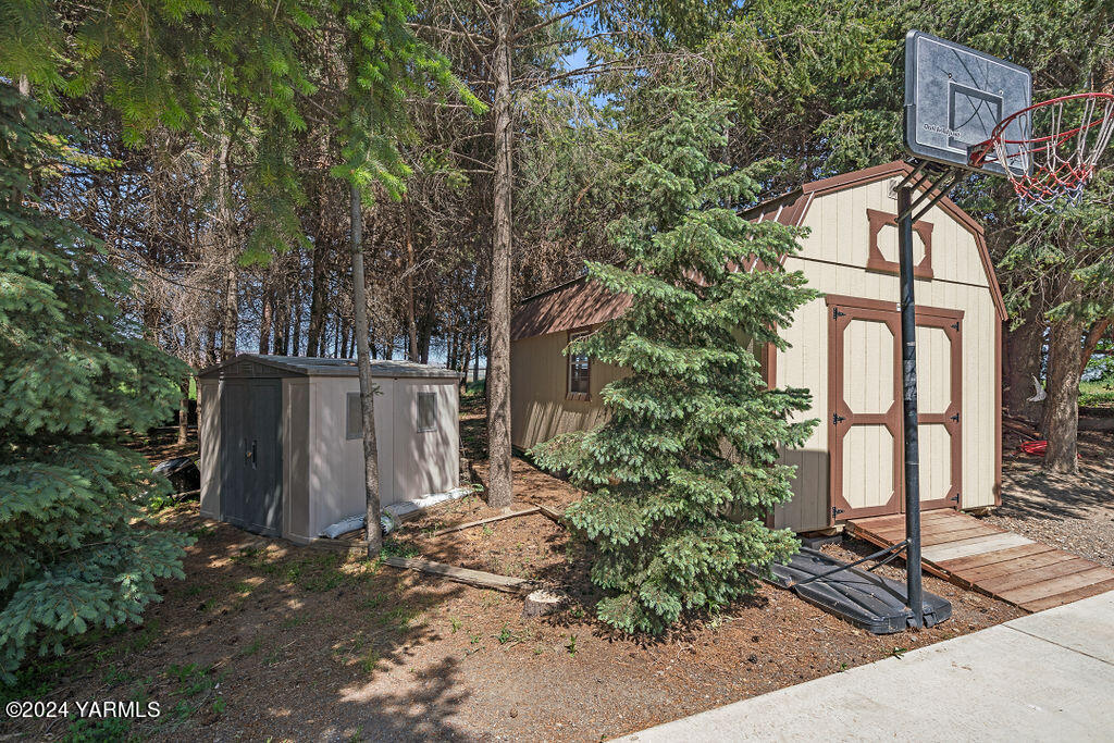 1241 Nelson Road Granger, WA 98932 - Photo 39 of 45 a view of backyard with large trees and flower plants