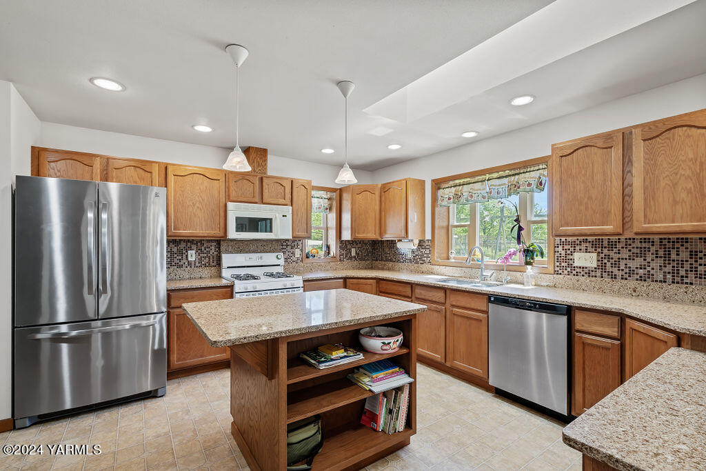 1241 Nelson Road Granger, WA 98932 - Photo 8 of 45 a kitchen with stainless steel appliances granite countertop a sink stove and refrigerator