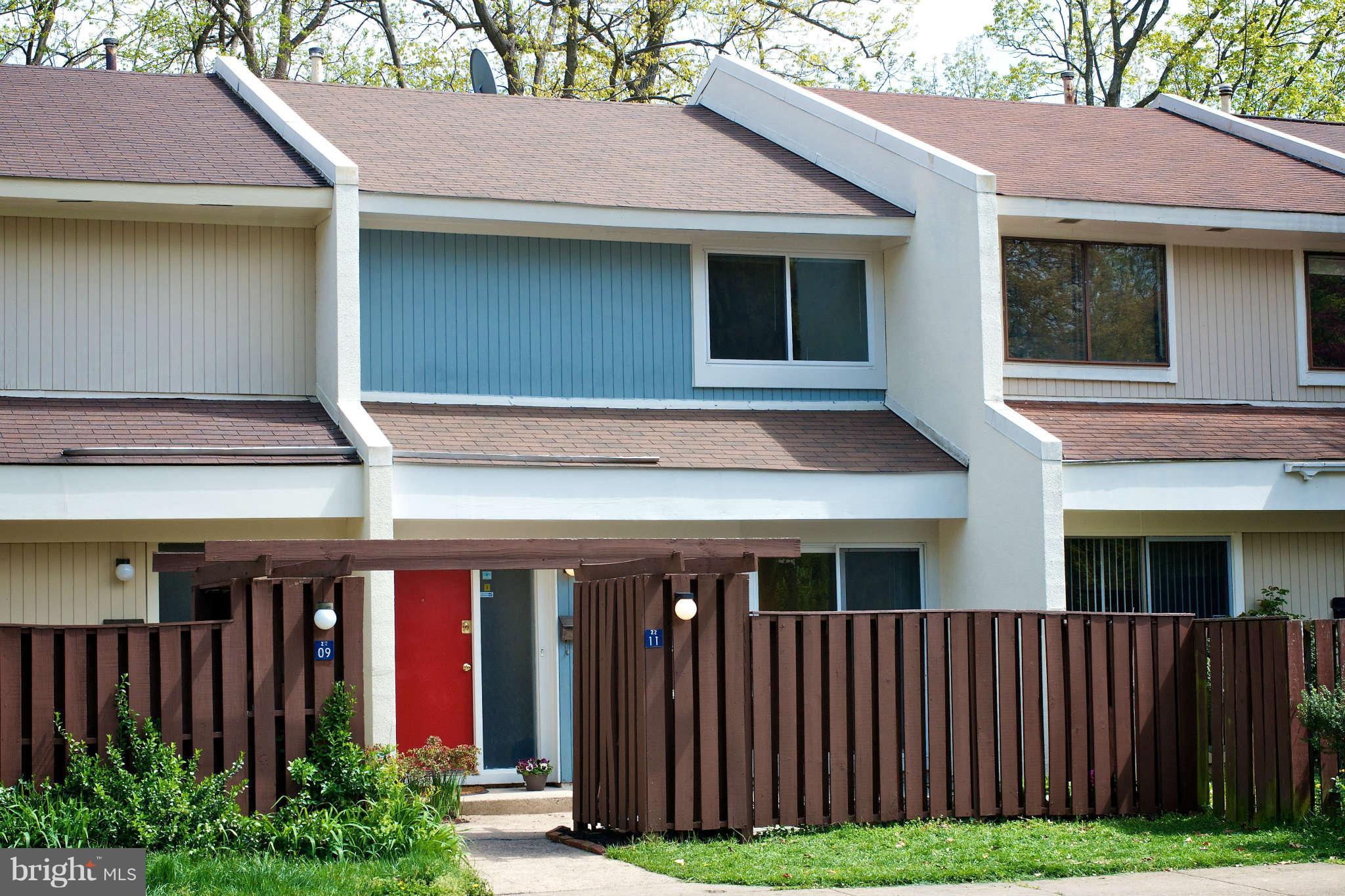 2211 Southgate Square Reston, VA 20191 - Photo 1 of 26 a front view of a house with garden