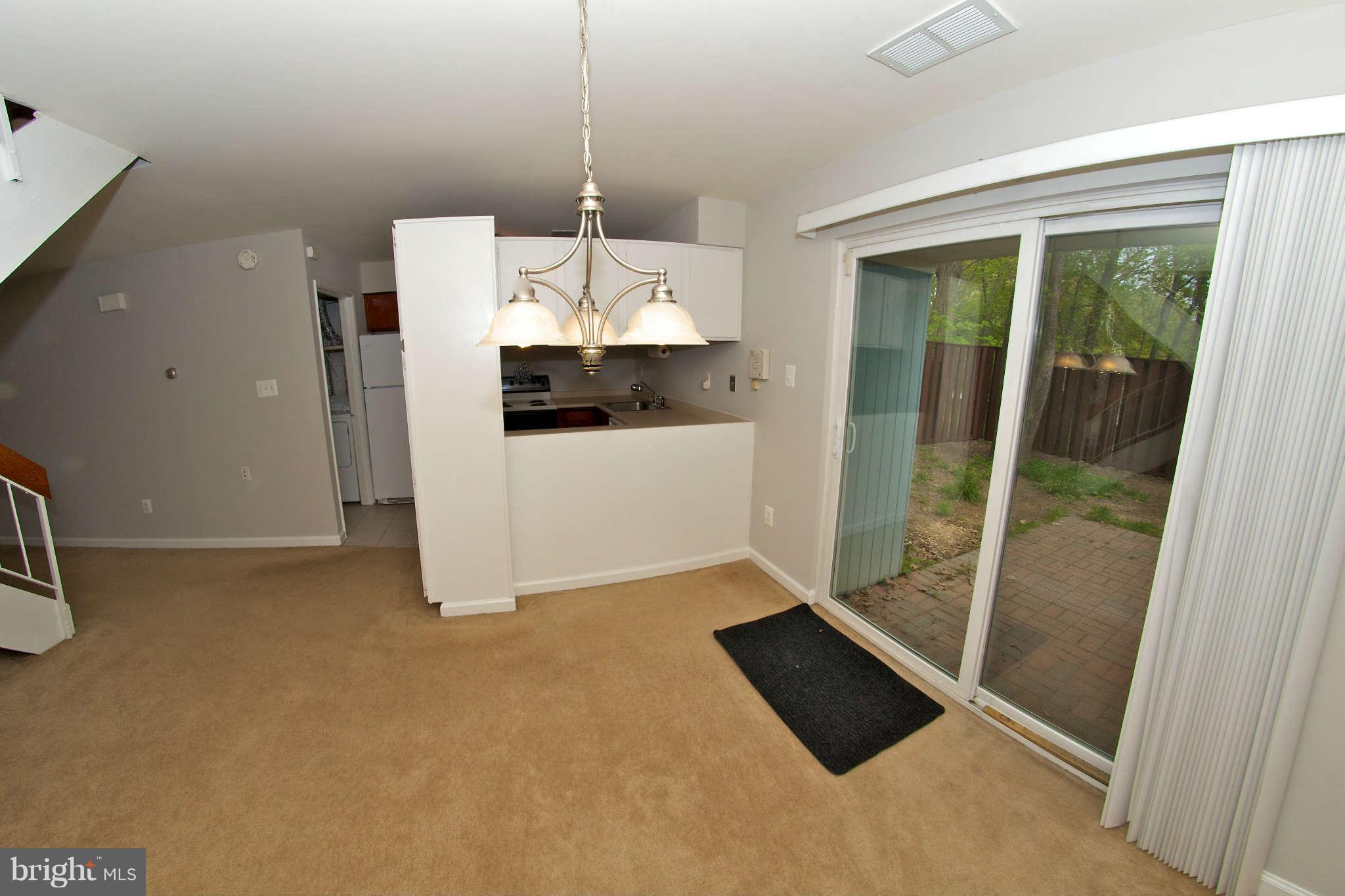 2211 Southgate Square Reston, VA 20191 - Photo 7 of 26 a view of a room with a floor to ceiling window and kitchen view