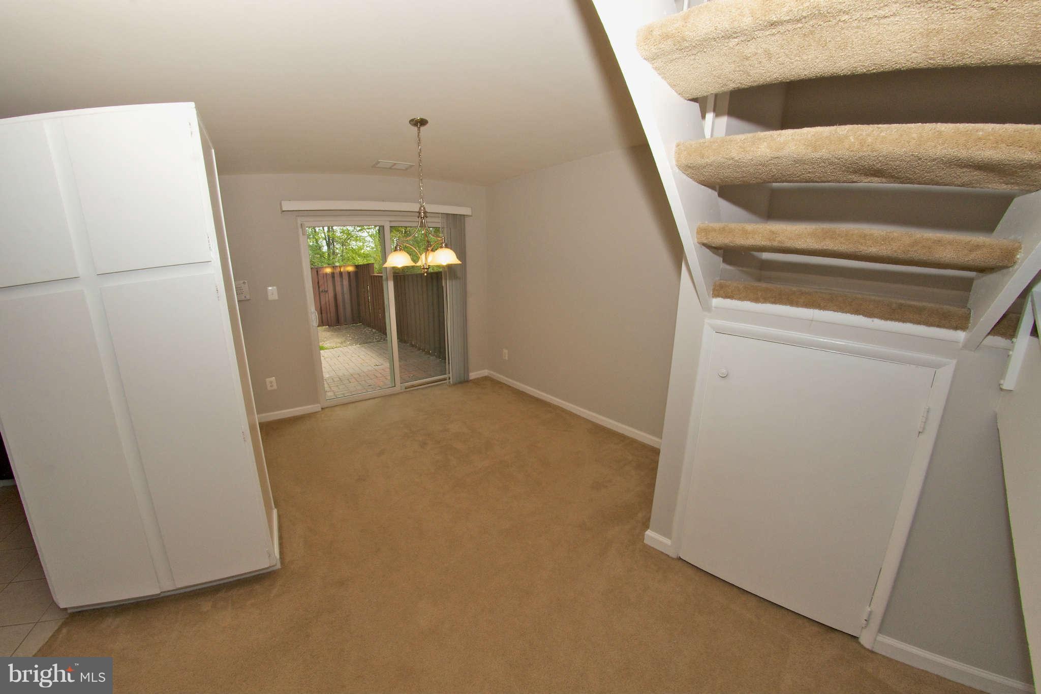 2211 Southgate Square Reston, VA 20191 - Photo 9 of 26 a view of hallway with stairs and a refrigerator