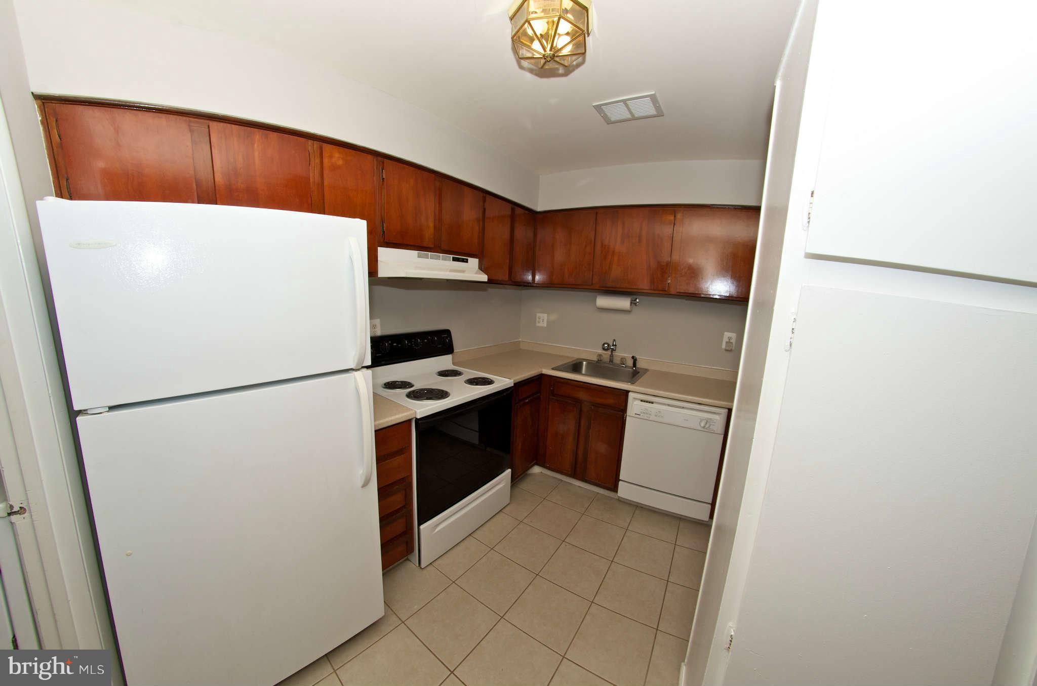 2211 Southgate Square Reston, VA 20191 - Photo 10 of 26 a white refrigerator freezer sitting inside of a kitchen