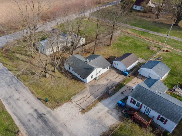 an aerial view of a house with a yard