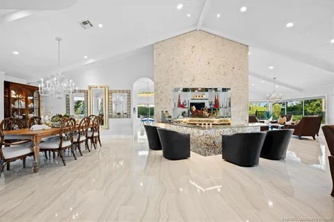 a view of a dining room with furniture and chandelier