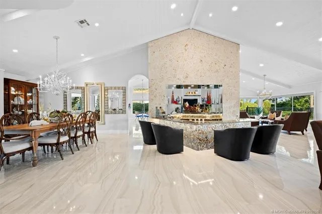 a view of a dining room with furniture and chandelier