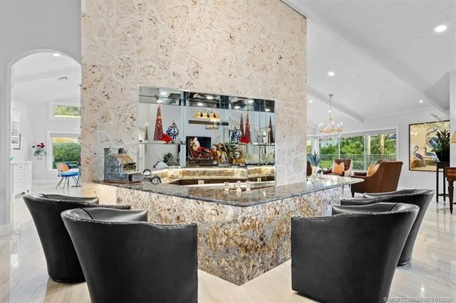 a kitchen with stainless steel appliances granite countertop a sink and a refrigerator