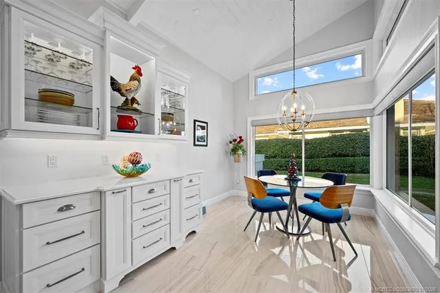 a bedroom with a bed a couch and a chandelier